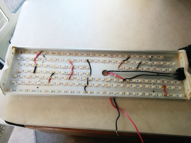 LEDs glued down and soldered to each other in the older fluorescent fixture.
