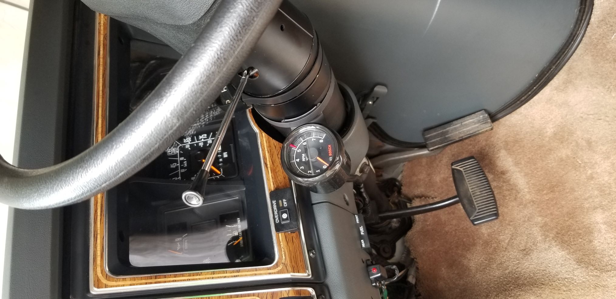 I wasn't brave enough to drill through the steering column so I painted a hose clamp black and mounted it. Doesn't seem like it will fall off but time will tell.